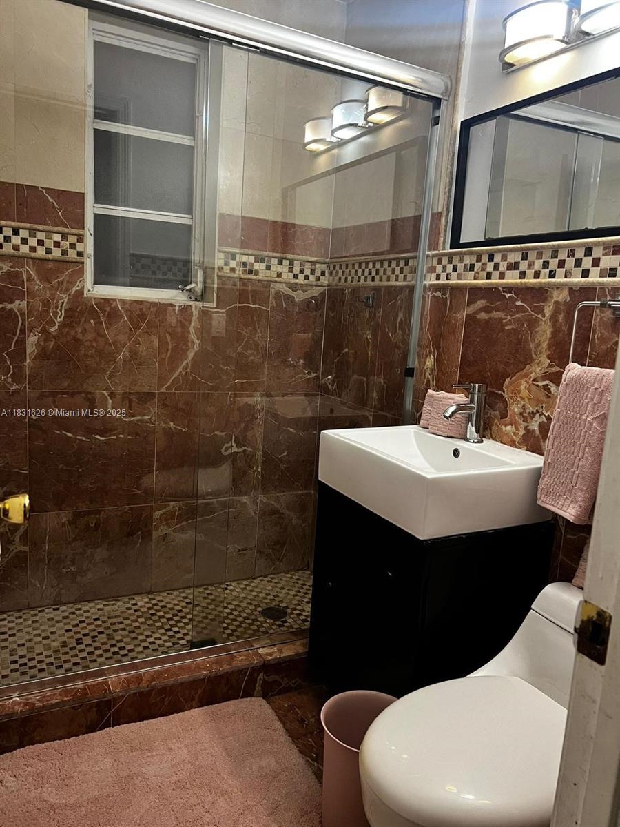 1227 Euclid Avenue, Unit 6 Miami Beach, FL 33139 - Photo 23 of 24 a bathroom with a sink toilet and shower