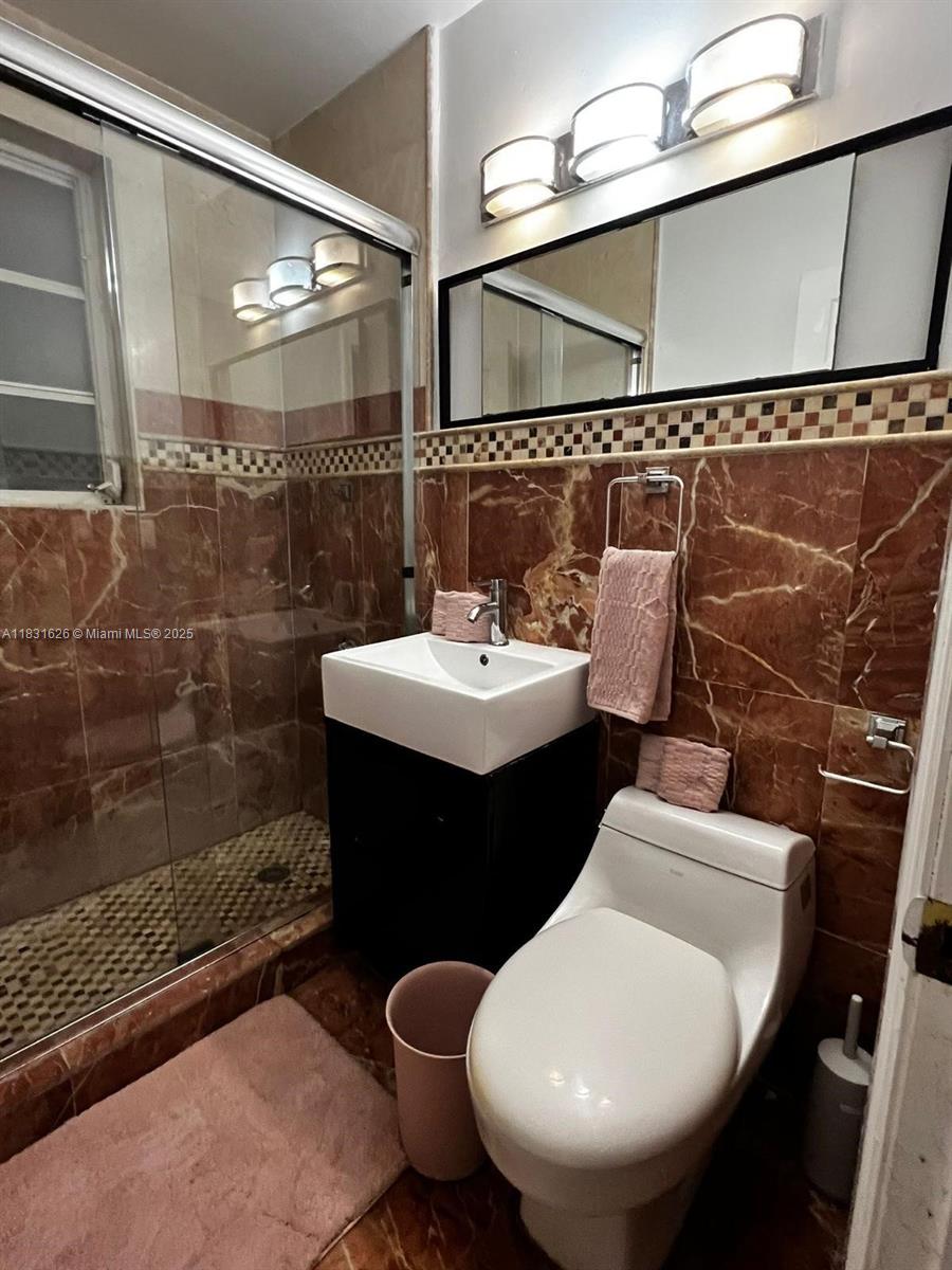 1227 Euclid Avenue, Unit 6 Miami Beach, FL 33139 - Photo 24 of 24 a bathroom with a sink toilet and shower