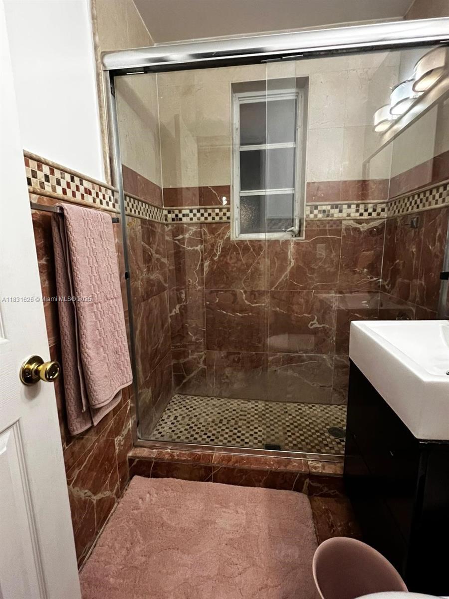 1227 Euclid Avenue, Unit 6 Miami Beach, FL 33139 - Photo 5 of 24 a bathroom with a shower and a sink