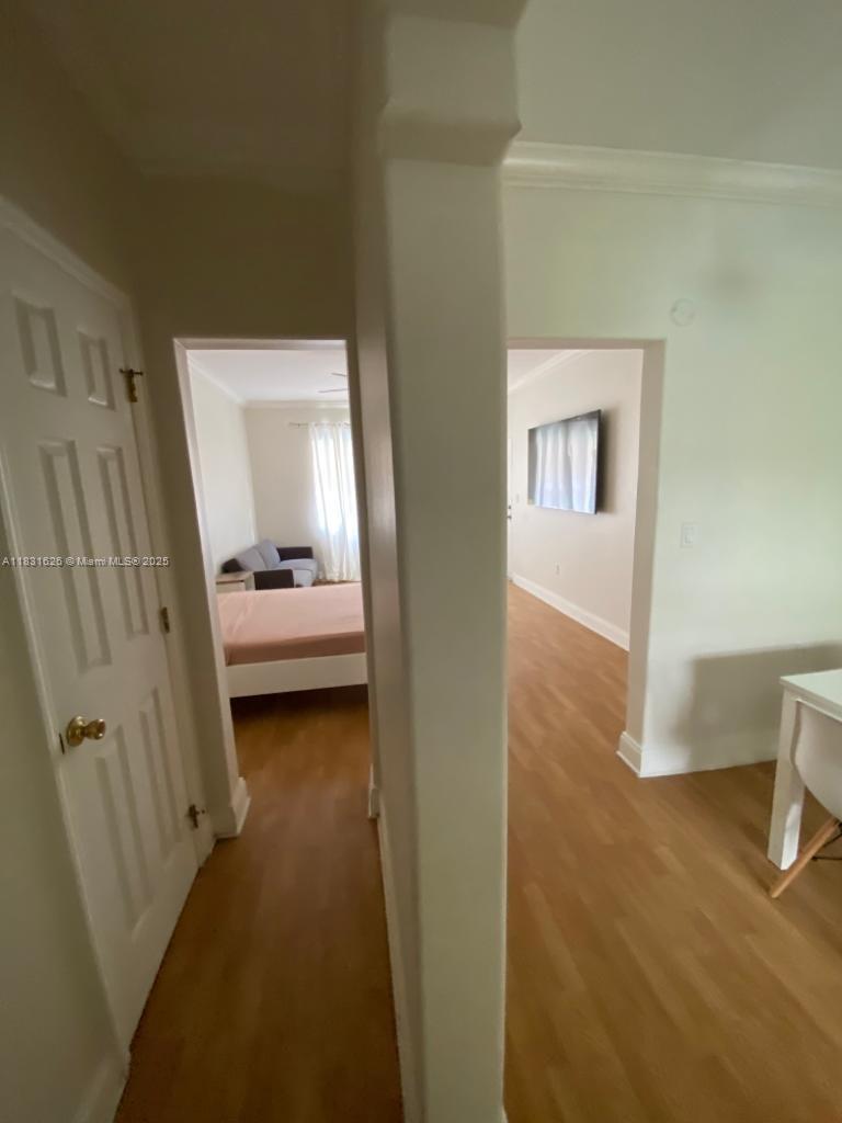 1227 Euclid Avenue, Unit 6 Miami Beach, FL 33139 - Photo 6 of 24 a bedroom with a bed and a chair