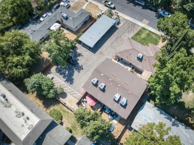 an aerial view of a house with a yard and potted plants