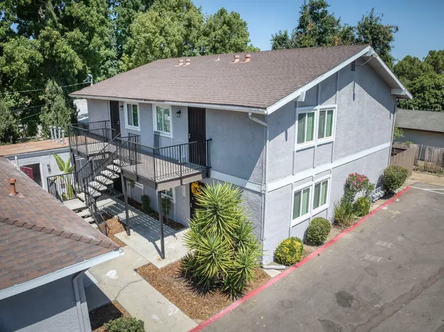 a aerial view of a house with table and chairs