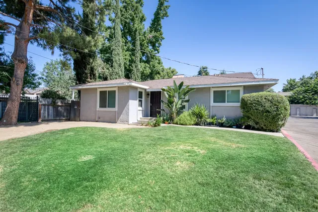 a front view of house with yard and green space