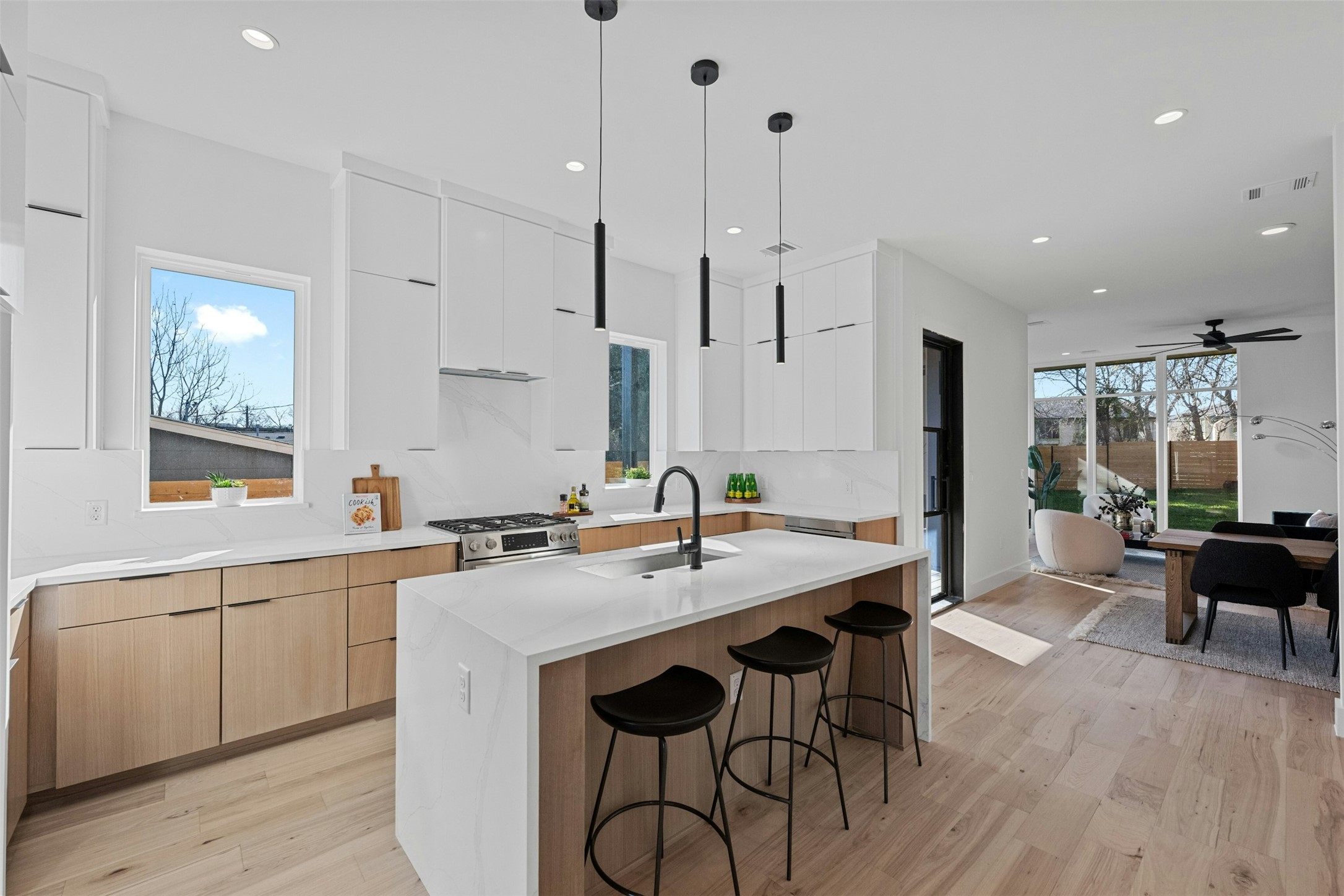 1407 Valleyridge Drive, Unit B Austin, TX 78704 - Photo 1 of 25 Kitchen featuring modern cabinets, white cabinetry, a kitchen bar, light wood-type flooring, and recessed lighting