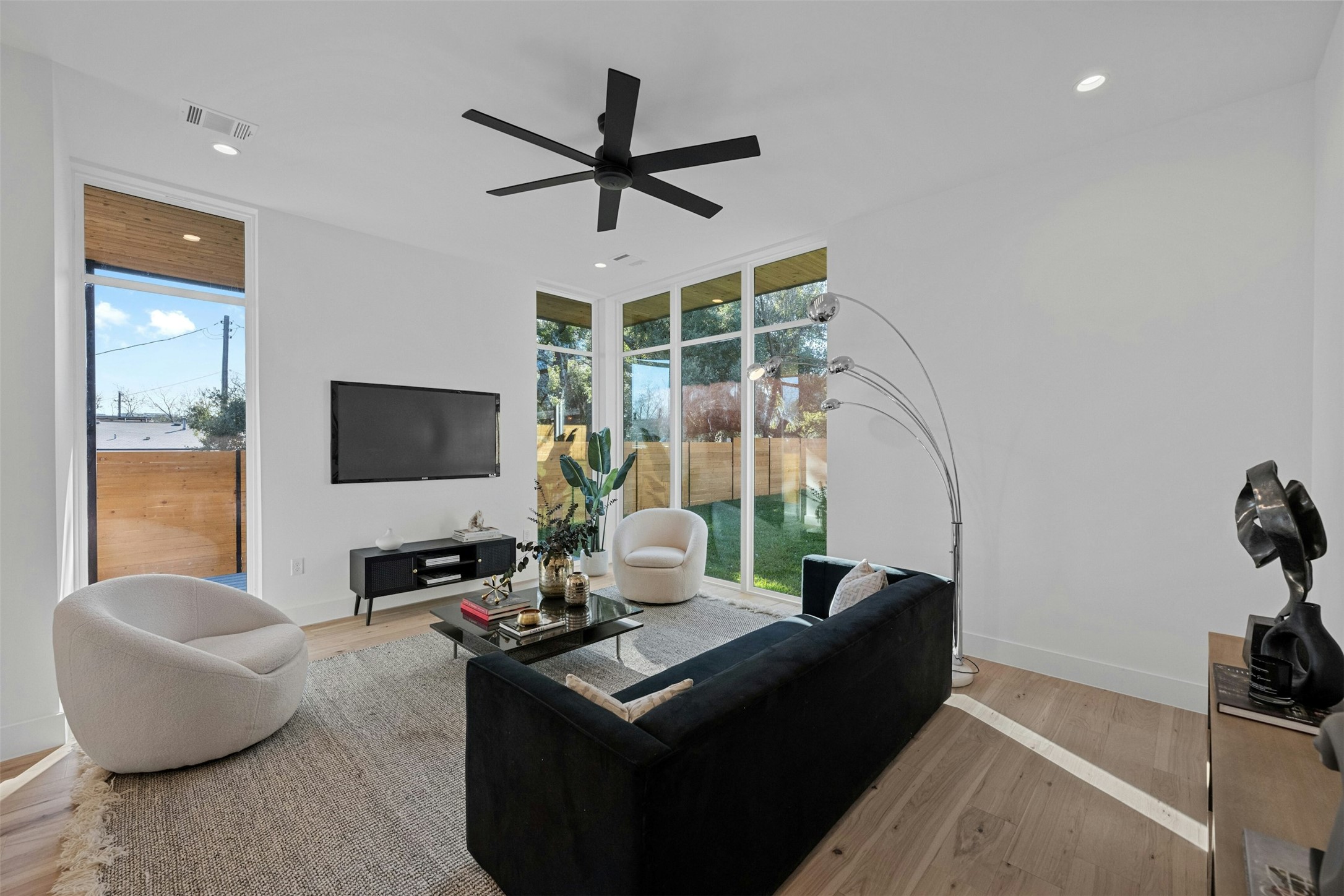 1407 Valleyridge Drive, Unit B Austin, TX 78704 - Photo 3 of 25 Living room with recessed lighting, light wood-style flooring, a ceiling fan, and expansive windows