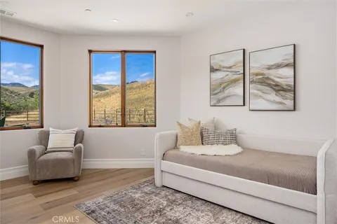 a bedroom with a bed and a large window
