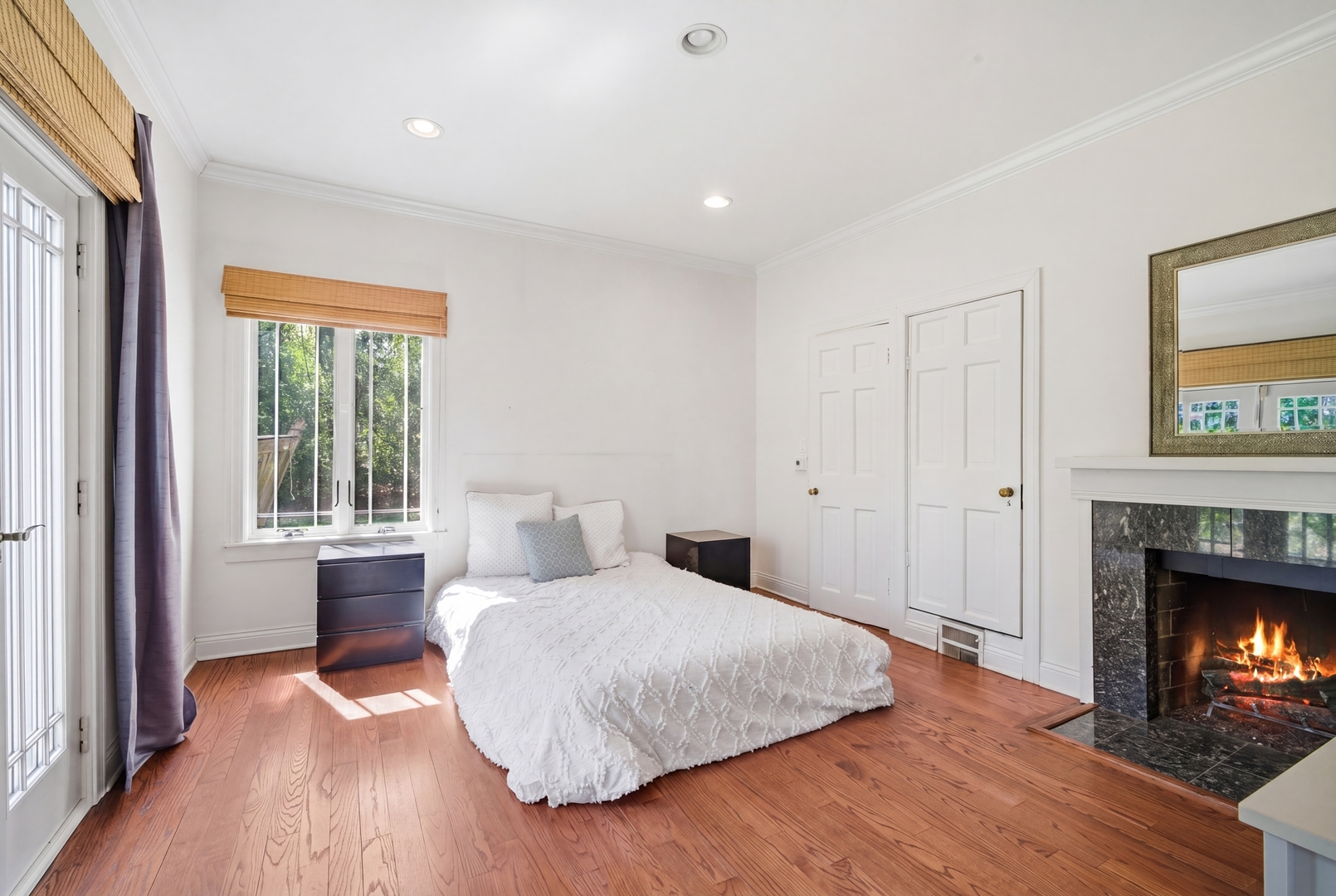 700 South Waukegan Road Lake Forest, IL 60045 - Photo 12 of 22 a bedroom with a bed and a fireplace