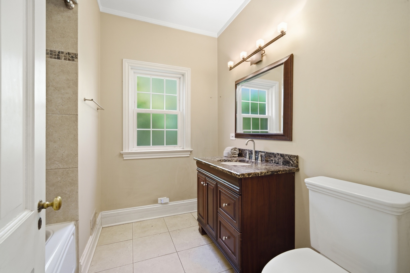 700 South Waukegan Road Lake Forest, IL 60045 - Photo 10 of 22 a bathroom with a granite countertop sink toilet a mirror and a window
