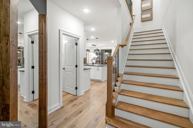 a view of a hallway with wooden floor and entryway