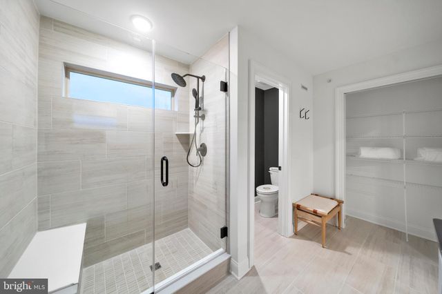 a bathroom with a shower and a toilet