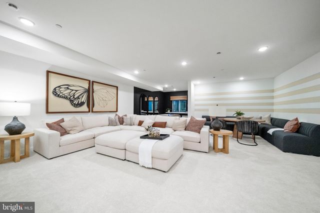 a living room with couches and a flat screen tv