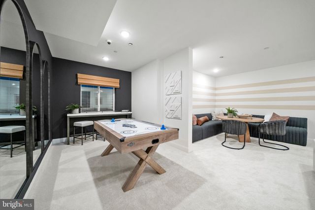 a room with table chairs and windows