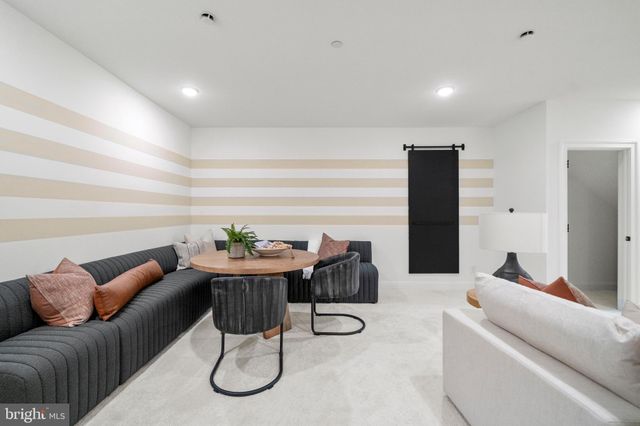 a living room with furniture a dining table and a refrigerator
