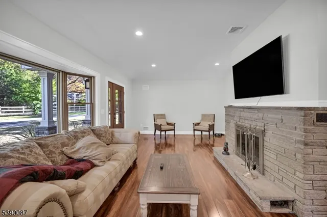 a living room with fireplace furniture and a flat screen tv