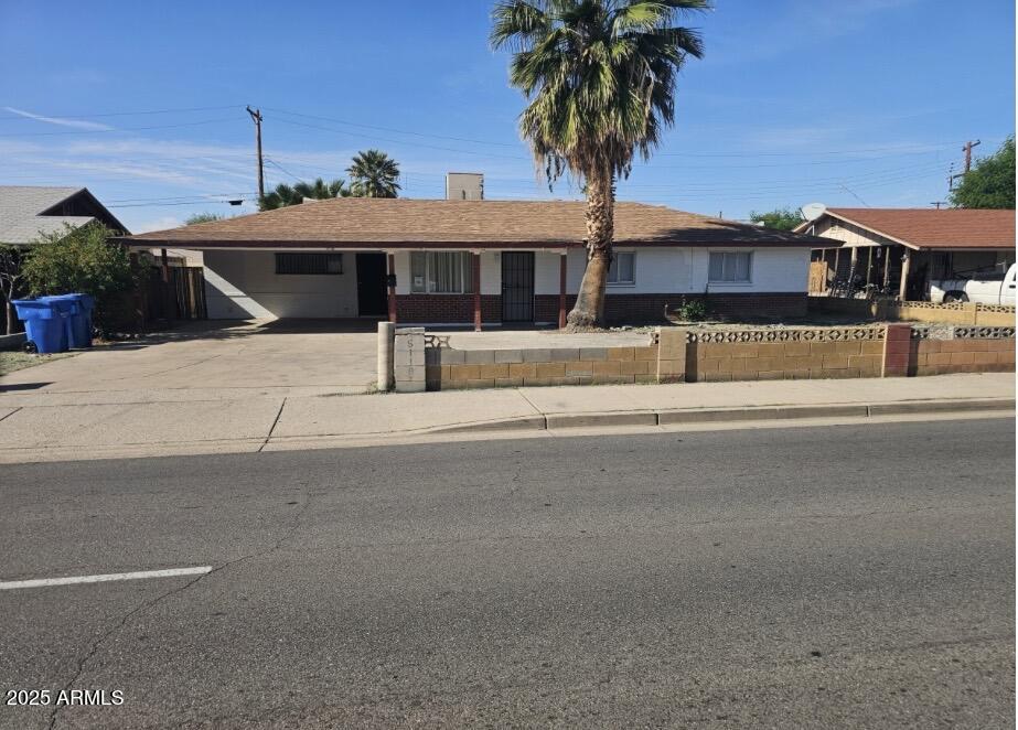 5118 North 35th Avenue Phoenix, AZ 85017 - Photo 1 of 5 a front view of a house with a yard and garage