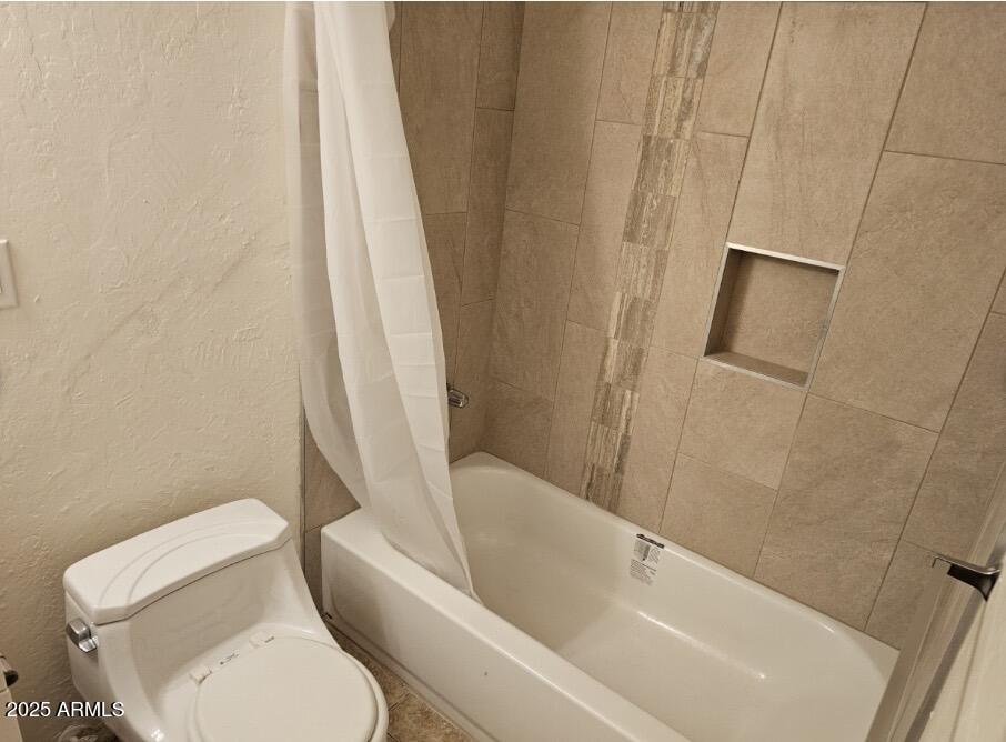 5118 North 35th Avenue Phoenix, AZ 85017 - Photo 4 of 5 a white toilet sitting next to a bath tub
