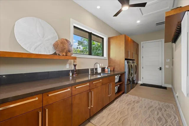 a kitchen with stainless steel appliances granite countertop a sink a stove and a refrigerator