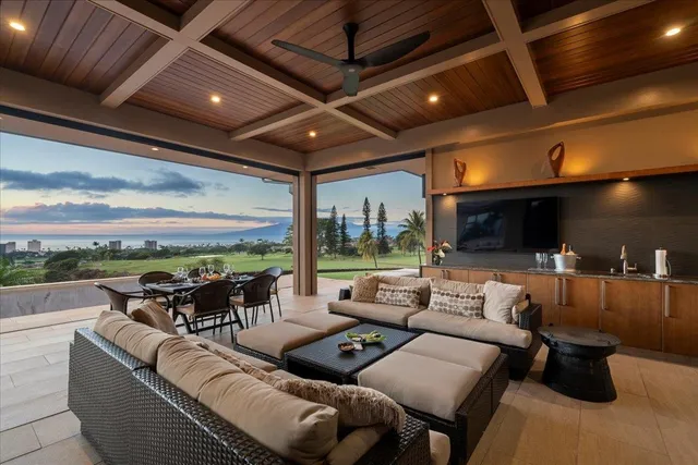 a living room with furniture and a floor to ceiling window