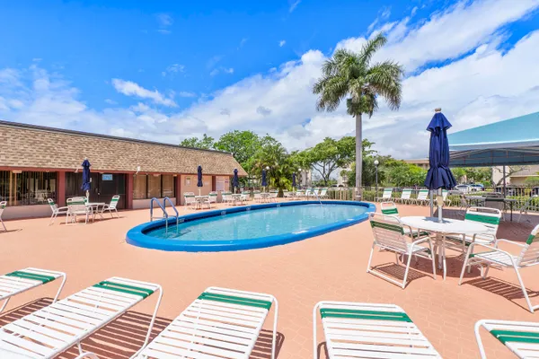 a view of a swimming pool with outdoor seating and plants