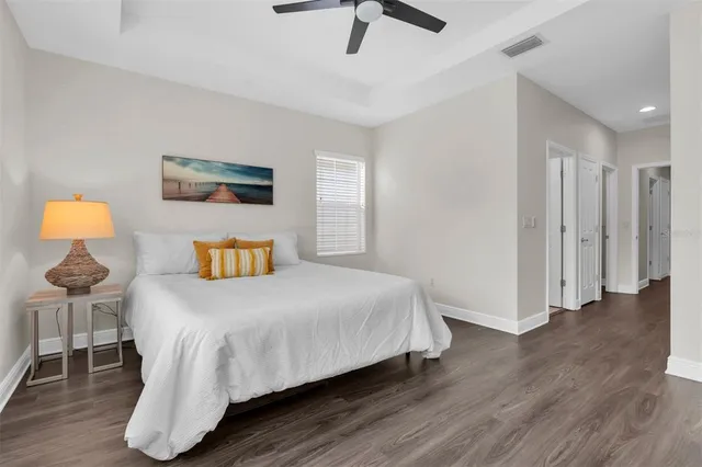 a bedroom with a bed and wooden floor