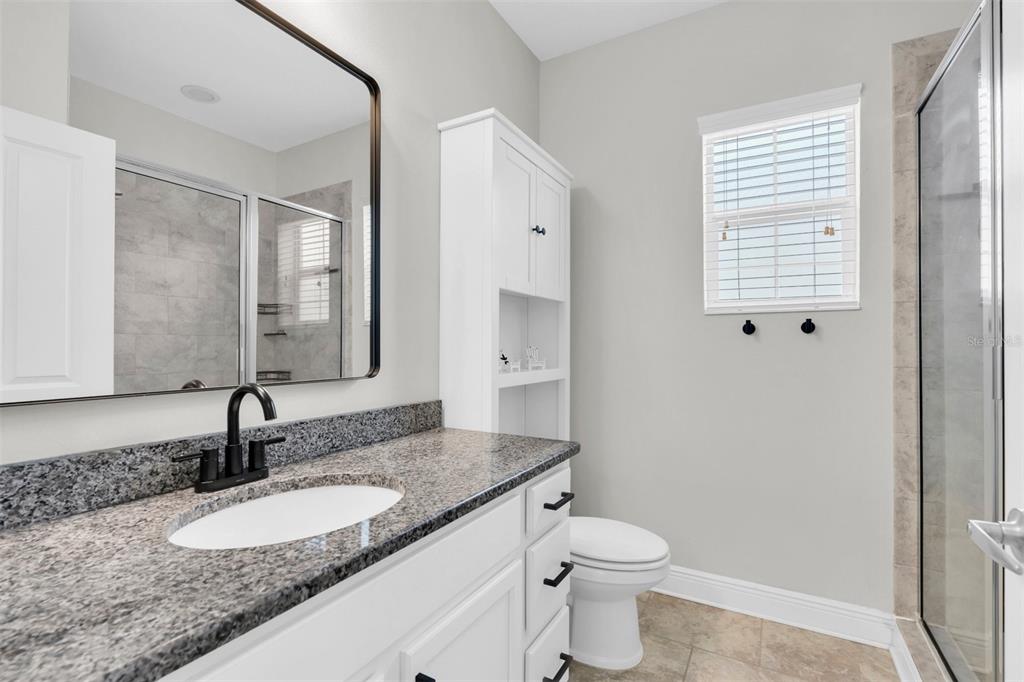 106 Cutlass Way Oldsmar, FL 34677 - Photo 14 of 23 a bathroom with a granite countertop sink toilet and mirror