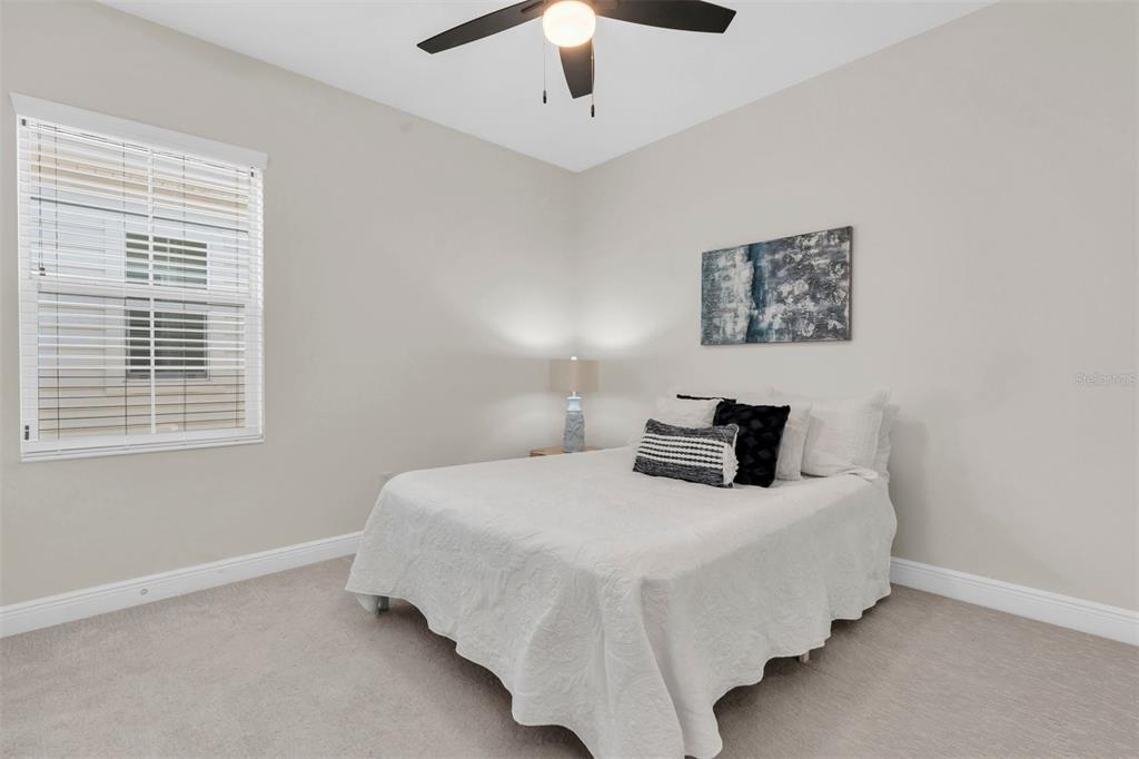 106 Cutlass Way Oldsmar, FL 34677 - Photo 17 of 23 a bedroom with a bed and a large window