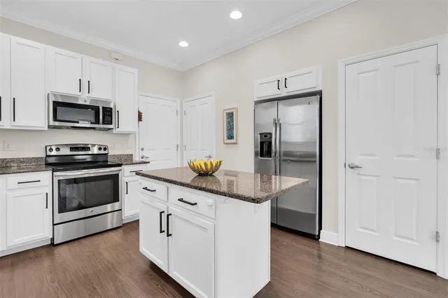 a kitchen with stainless steel appliances a white stove top oven and refrigerator