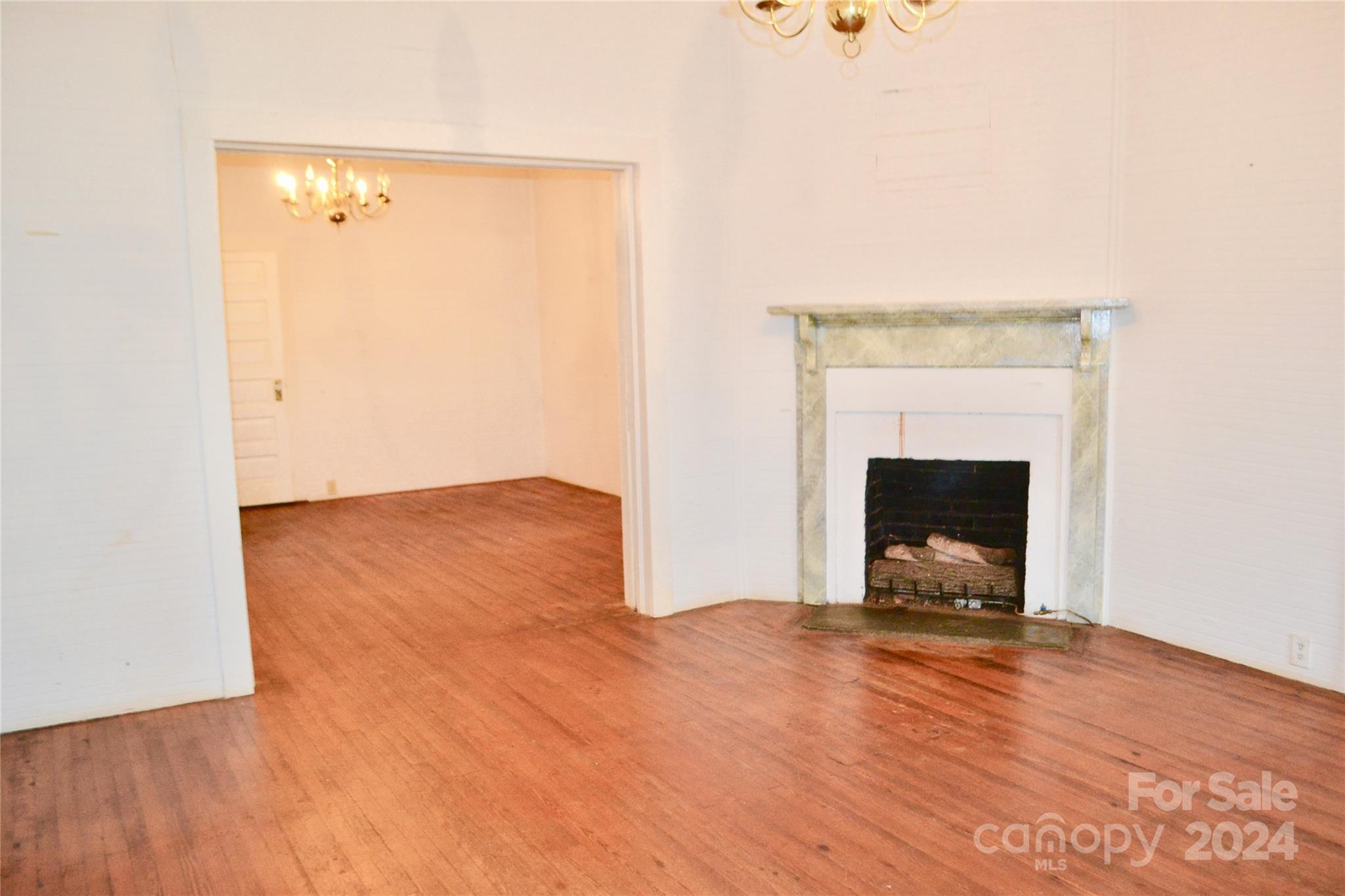 4298 Hudlow Road Rutherfordton, NC 28139 - Photo 18 of 38 a view of empty room with wooden floor and fireplace