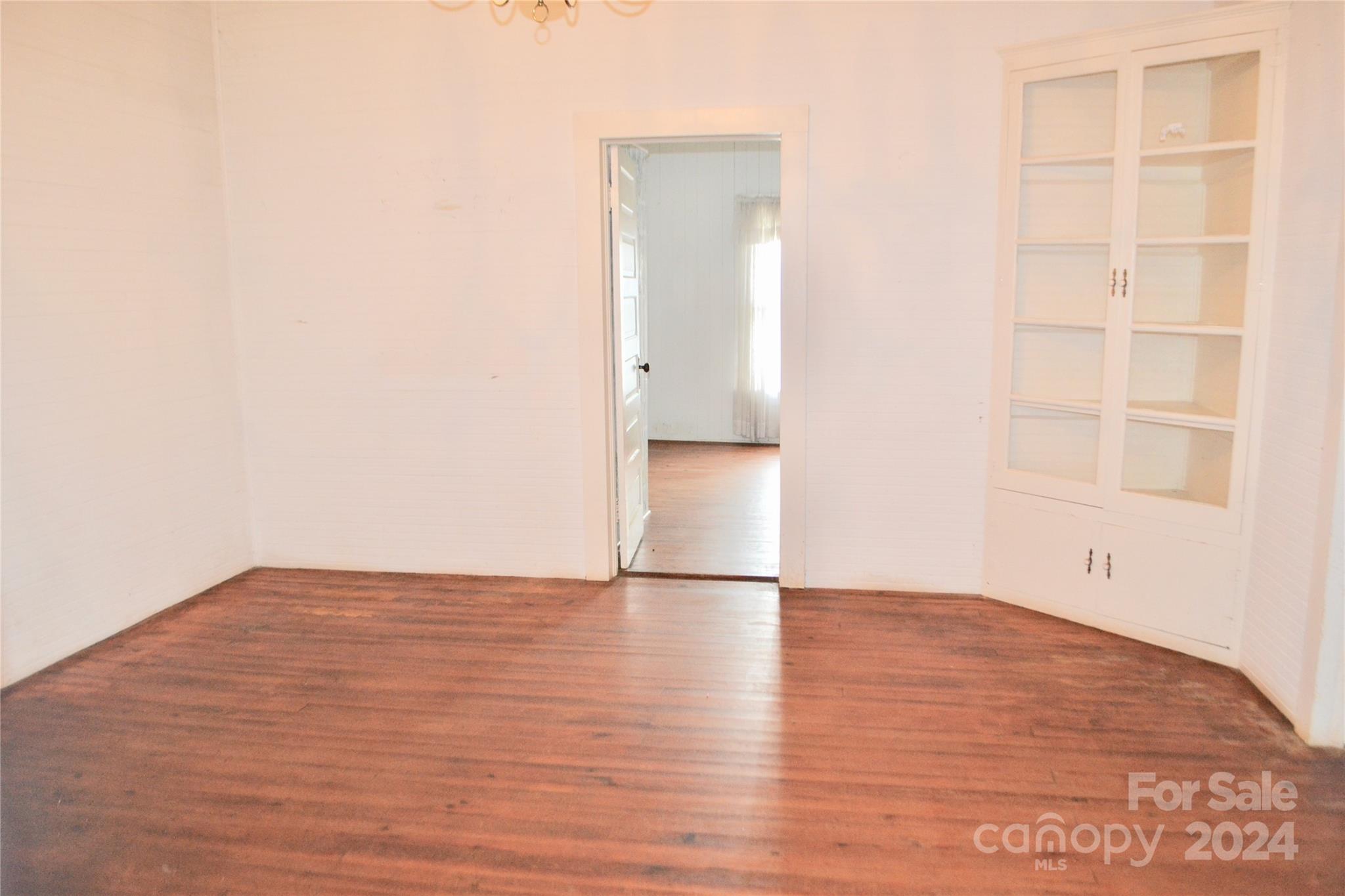 4298 Hudlow Road Rutherfordton, NC 28139 - Photo 21 of 38 a view of an empty room with wooden floor and a window