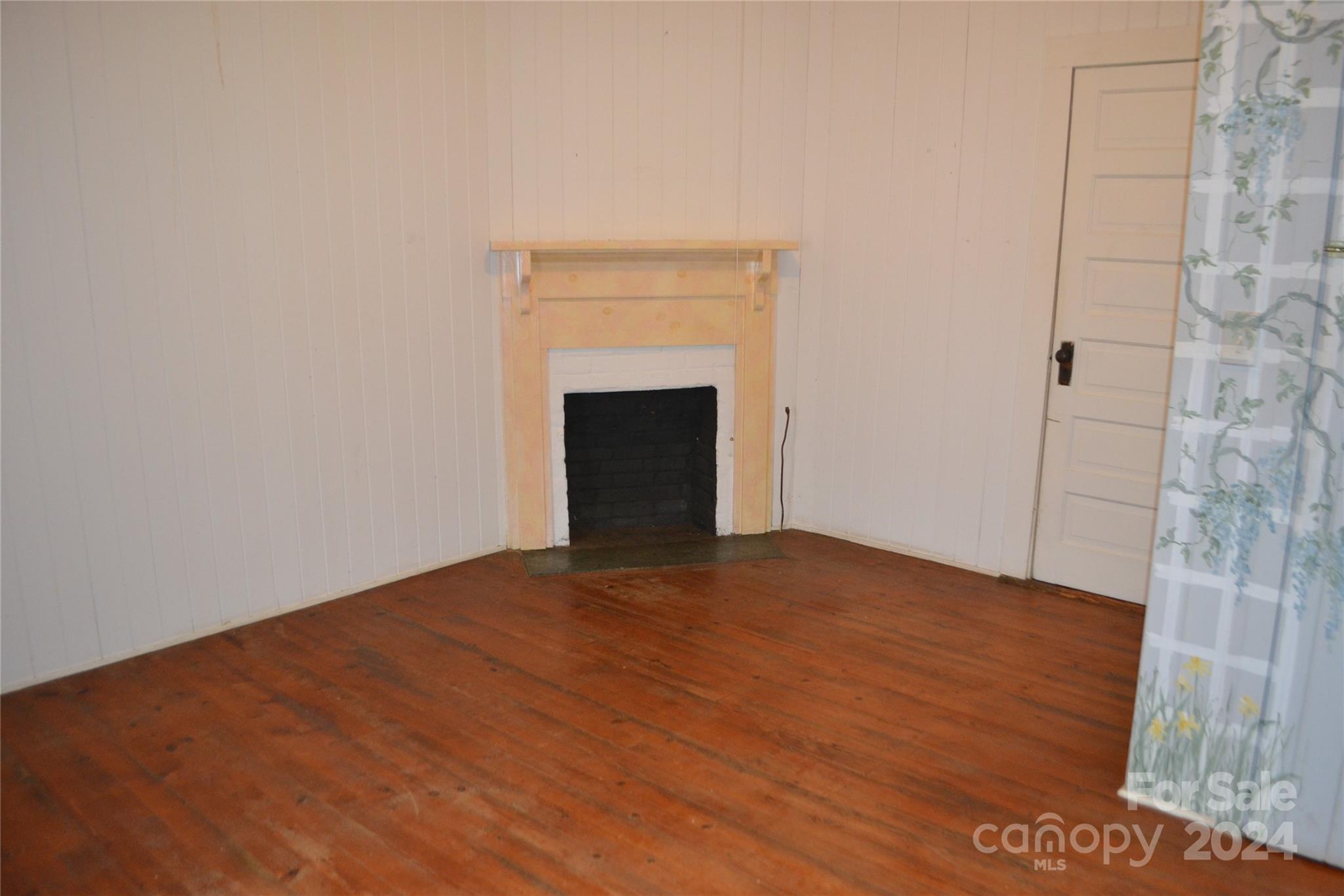 4298 Hudlow Road Rutherfordton, NC 28139 - Photo 26 of 38 a view of empty room with wooden floor and fireplace