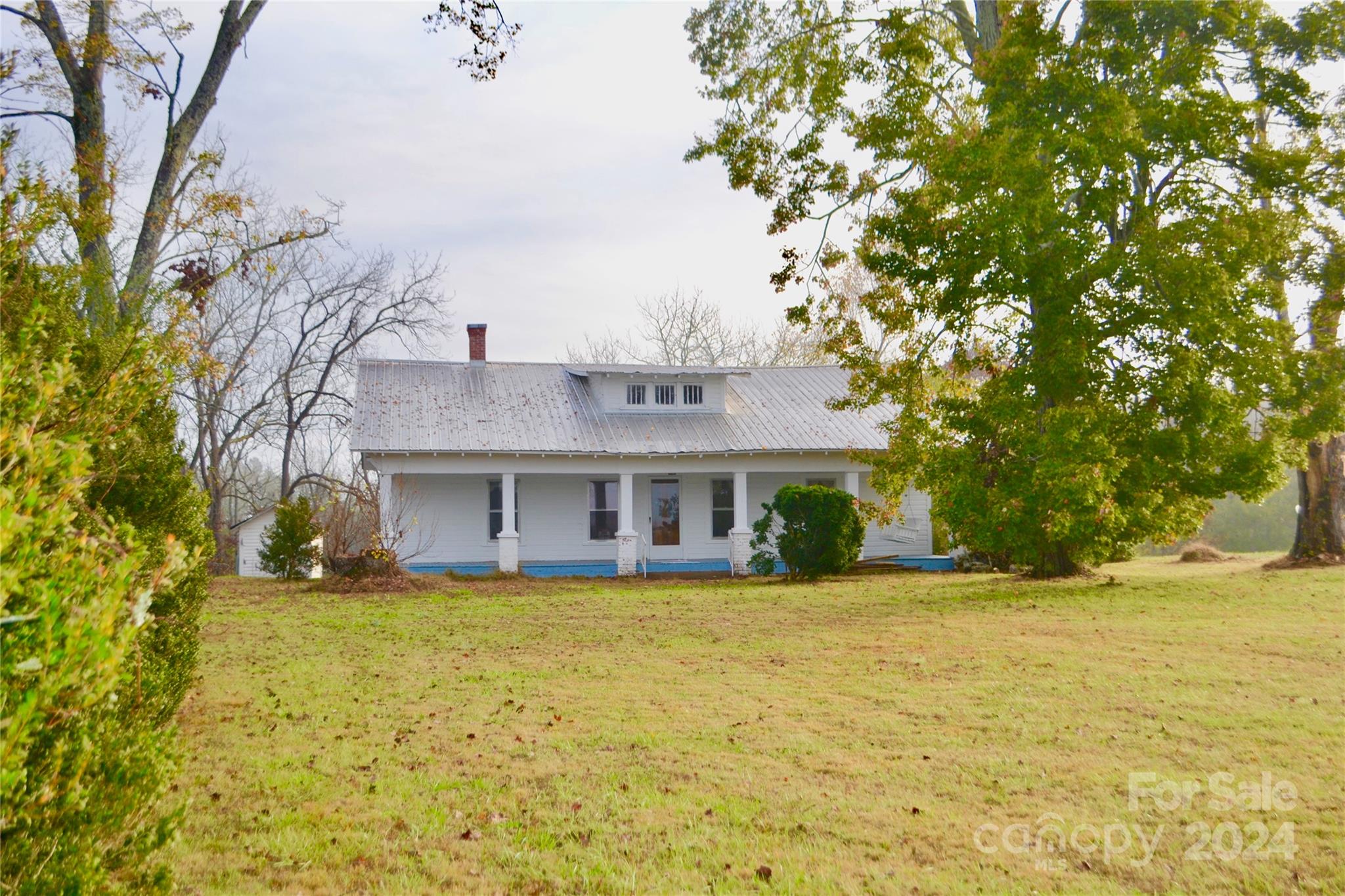 4298 Hudlow Road Rutherfordton, NC 28139 - Photo 3 of 38 a view of a house next to a yard with large trees