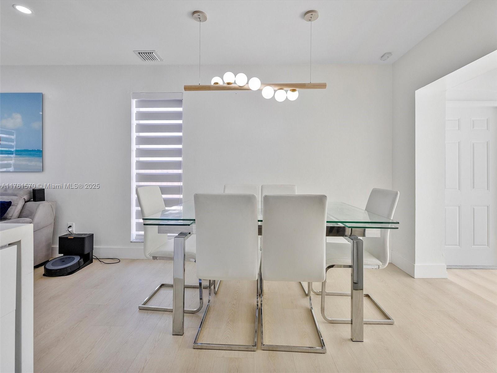 12744 Southwest 261st Terrace Homestead, FL 33032 - Photo 11 of 26 a view of a dining room with furniture and a chandelier