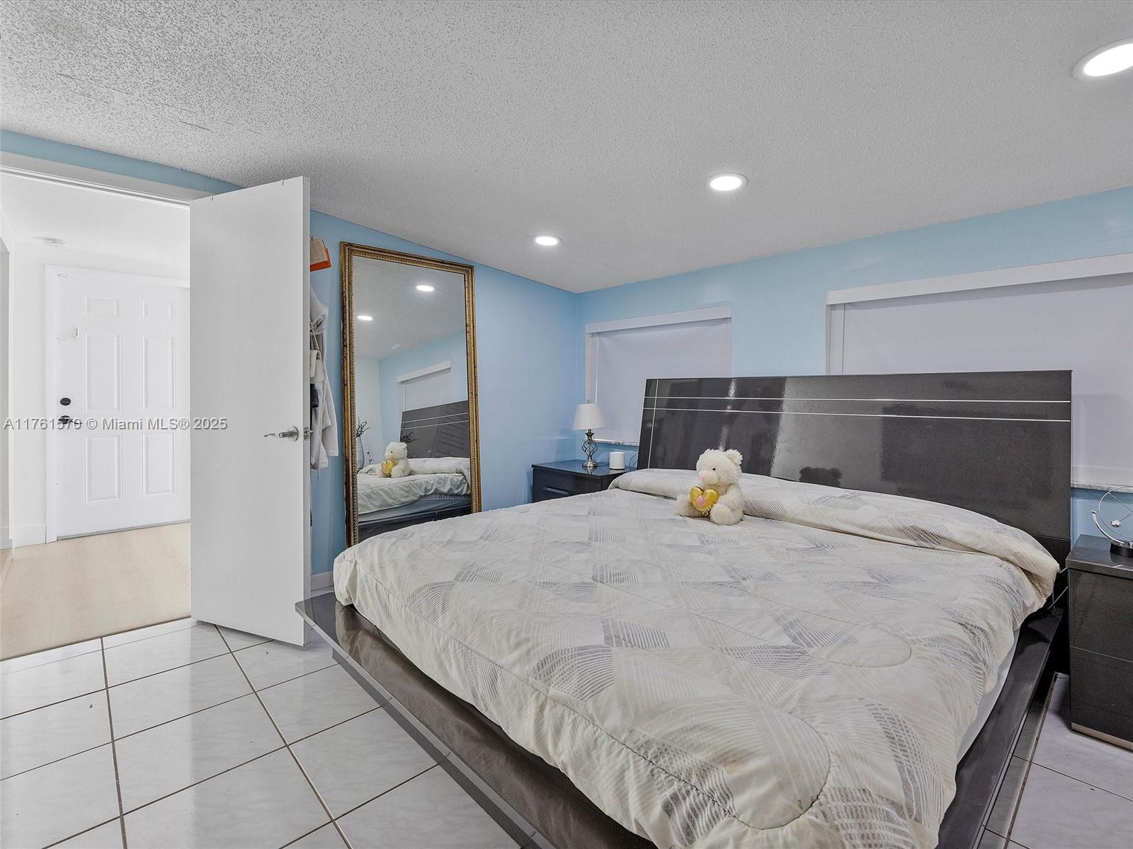 12744 Southwest 261st Terrace Homestead, FL 33032 - Photo 12 of 26 a spacious bedroom with a bed and a shower