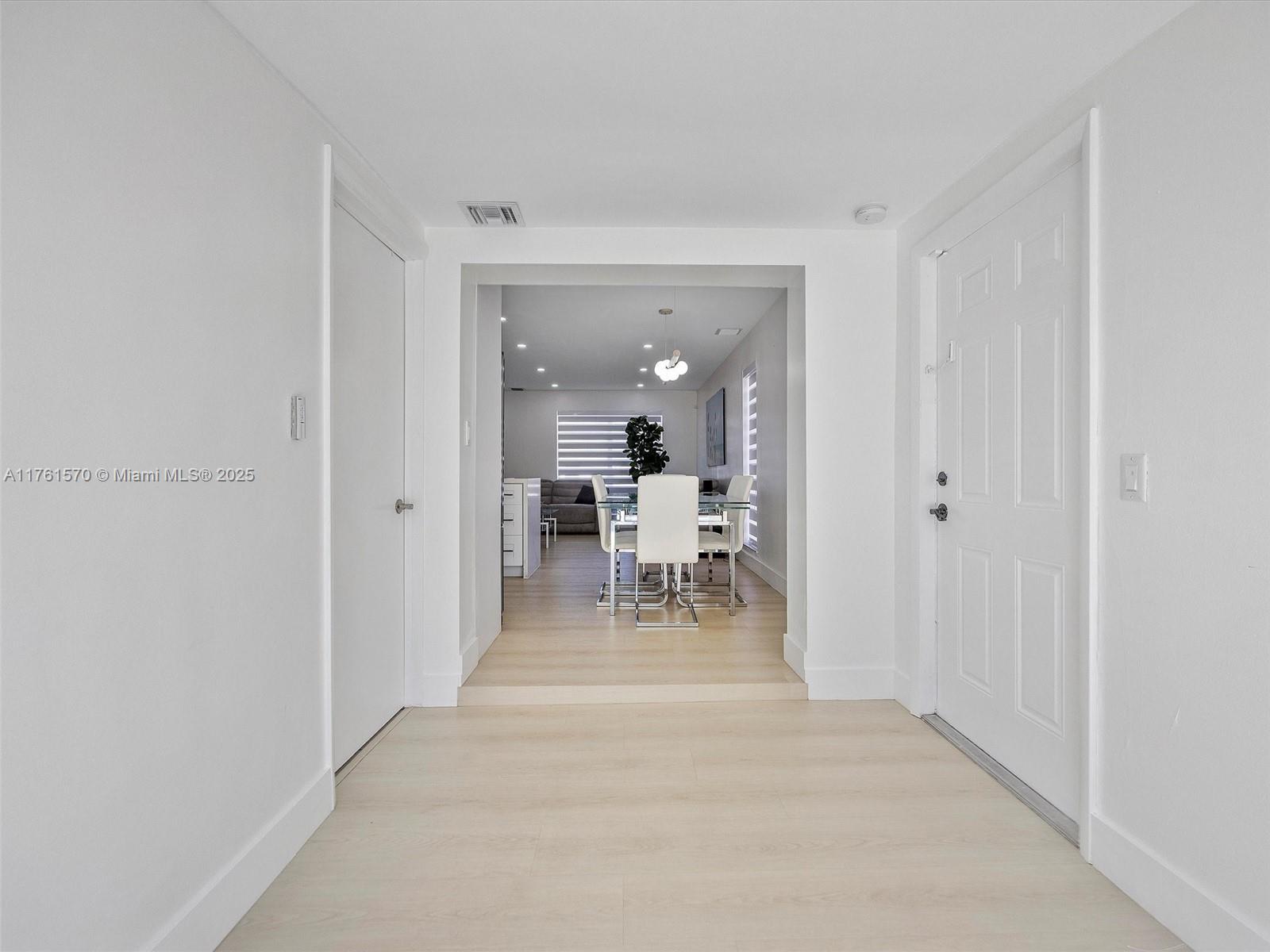 12744 Southwest 261st Terrace Homestead, FL 33032 - Photo 16 of 26 a view of a hallway with a chair and dining table chair