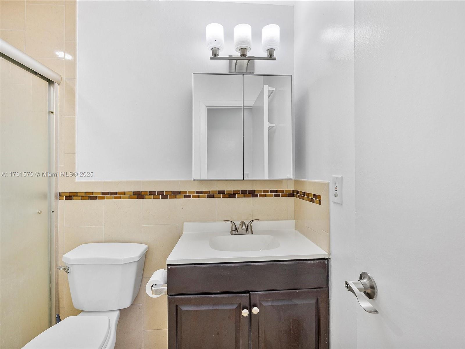 12744 Southwest 261st Terrace Homestead, FL 33032 - Photo 17 of 26 a bathroom with a sink a toilet and mirror
