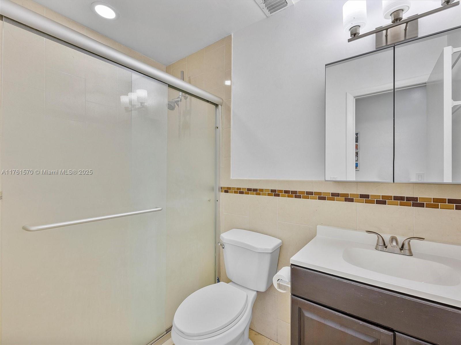 12744 Southwest 261st Terrace Homestead, FL 33032 - Photo 19 of 26 a bathroom with a sink a toilet and a mirror