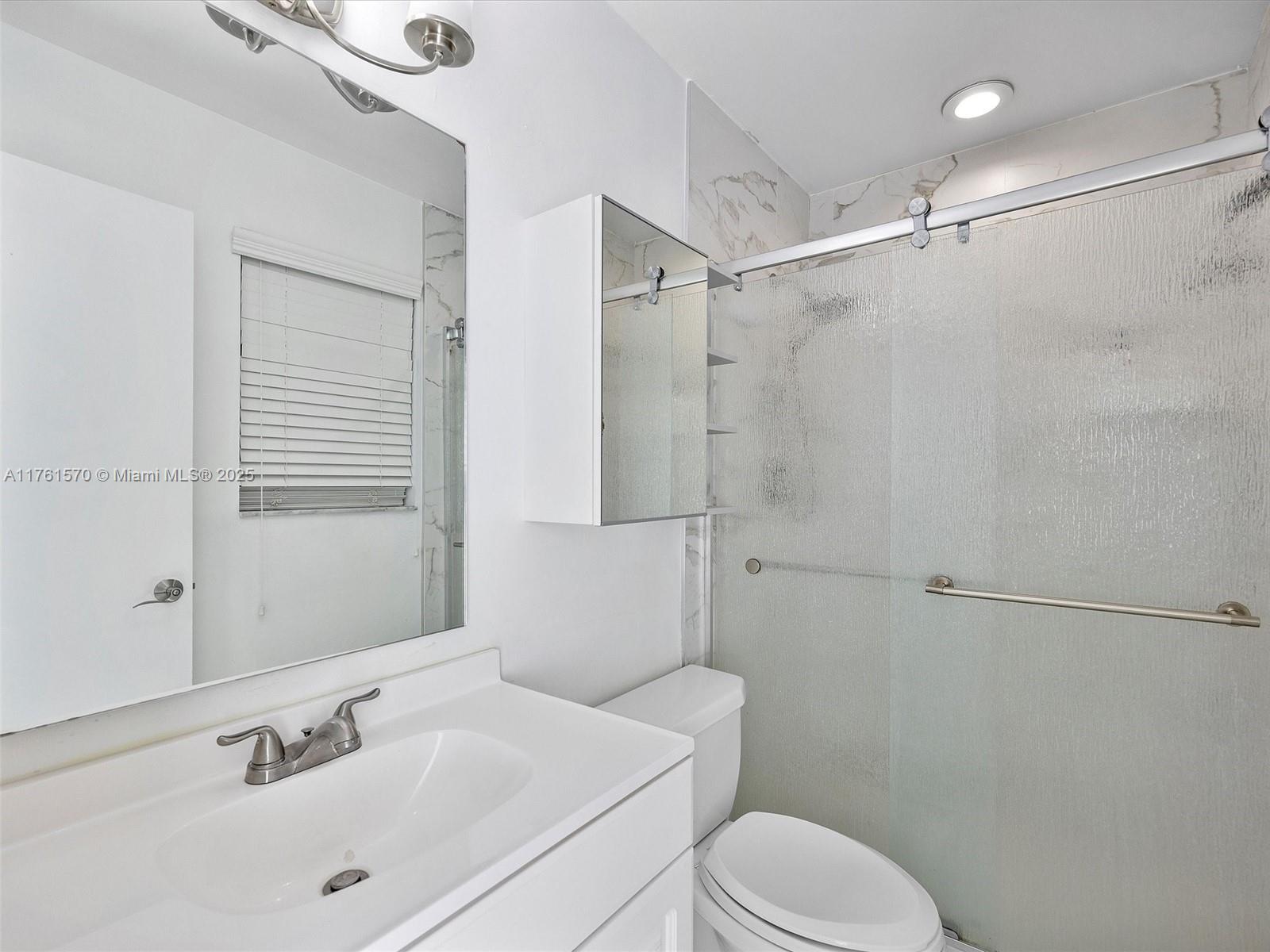 12744 Southwest 261st Terrace Homestead, FL 33032 - Photo 21 of 26 a bathroom with a sink toilet and shower