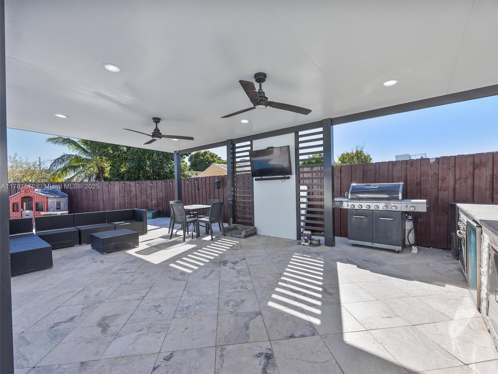 12744 Southwest 261st Terrace Homestead, FL 33032 - Photo 22 of 26 a view of a patio with a dining table and chairs