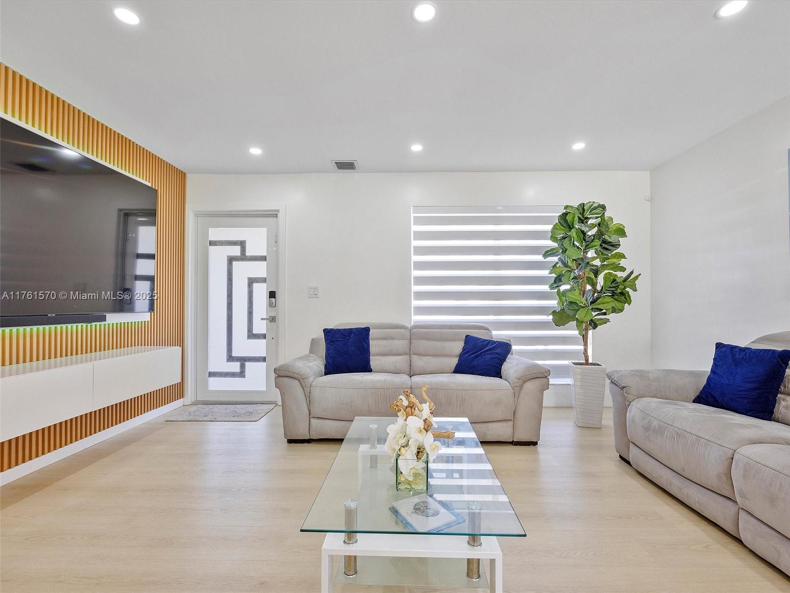 12744 Southwest 261st Terrace Homestead, FL 33032 - Photo 6 of 26 a living room with furniture and a large window