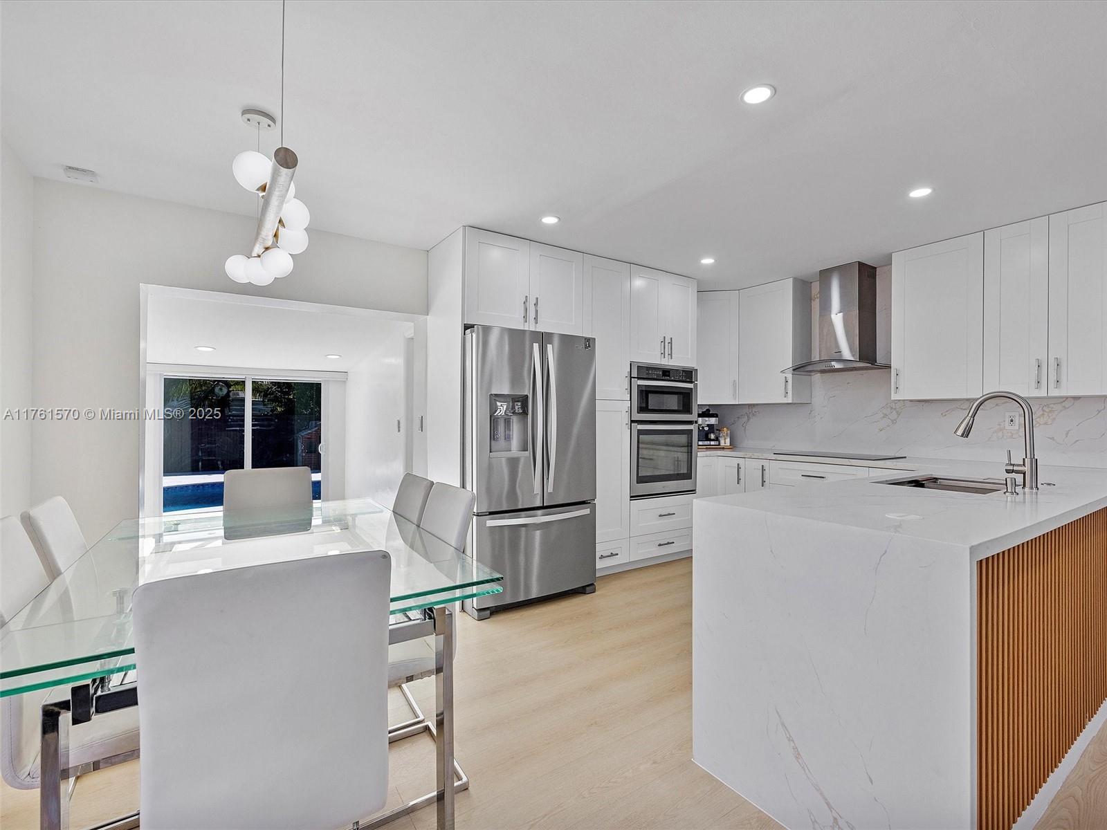 12744 Southwest 261st Terrace Homestead, FL 33032 - Photo 8 of 26 a kitchen with refrigerator cabinets and a sink