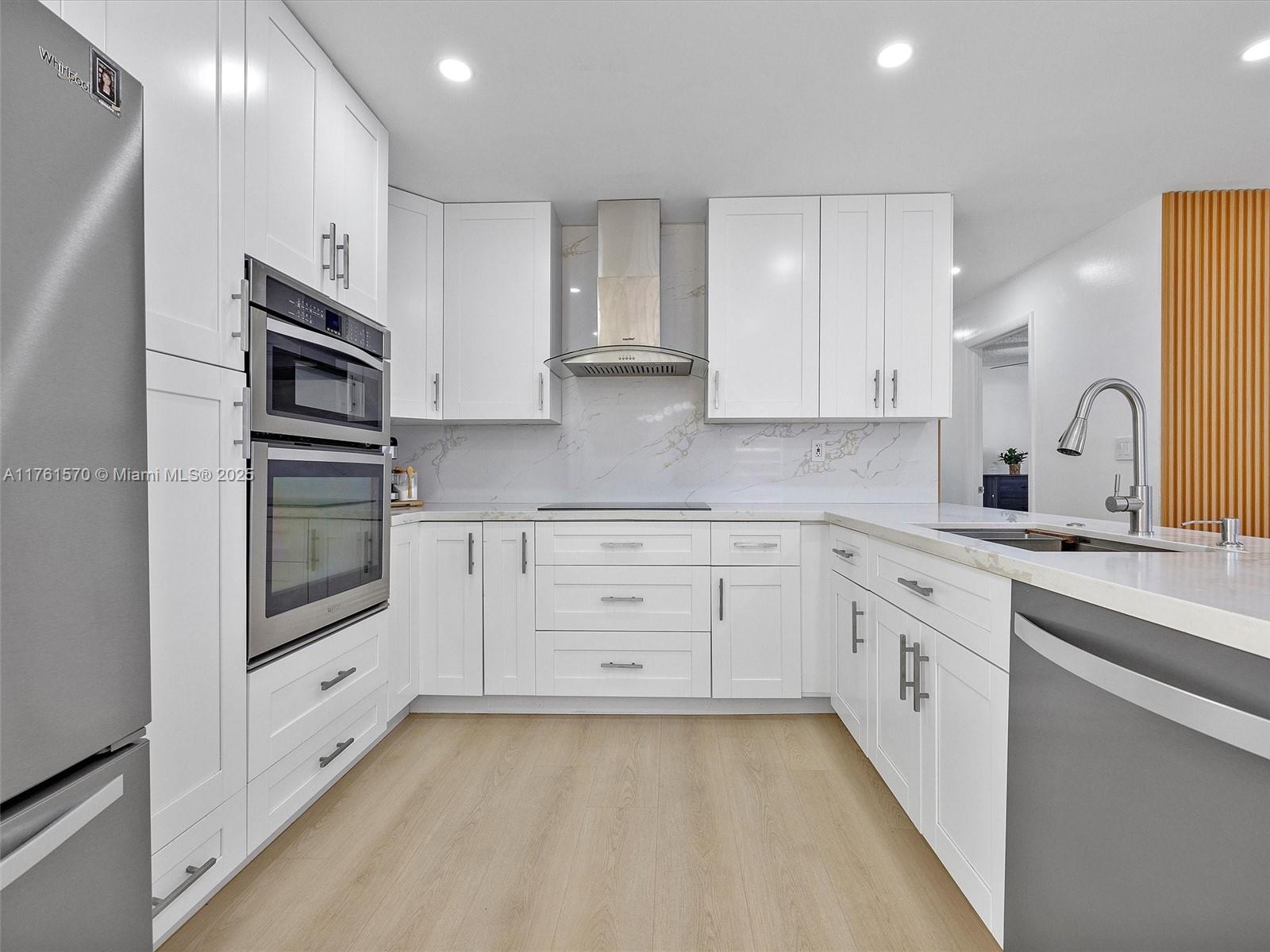 12744 Southwest 261st Terrace Homestead, FL 33032 - Photo 9 of 26 a kitchen with granite countertop white cabinets and stainless steel appliances