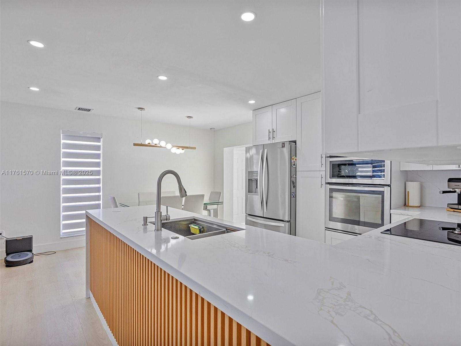 12744 Southwest 261st Terrace Homestead, FL 33032 - Photo 10 of 26 a kitchen with stainless steel appliances granite countertop a sink a stove and a refrigerator