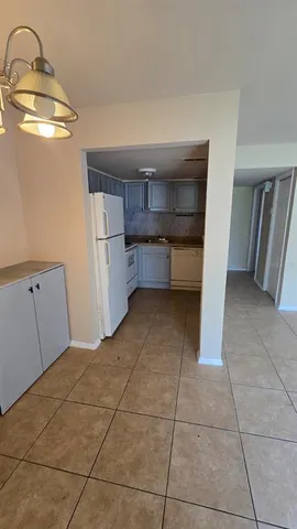 a kitchen with cabinets and window