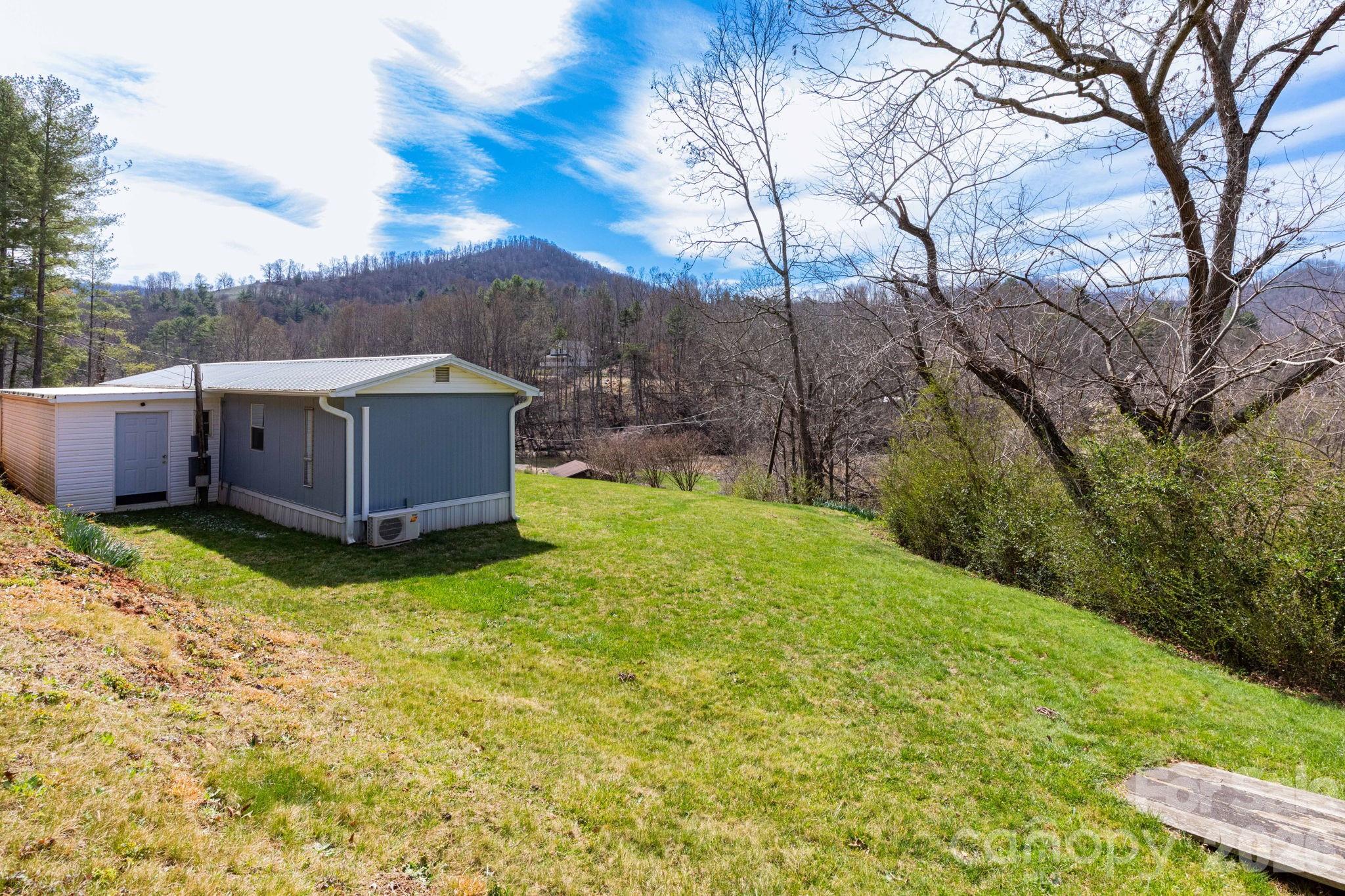 20 Ox Crk Road Weaverville, NC 28787 - Photo 6 of 22 a backyard of a house with yard and trampoline