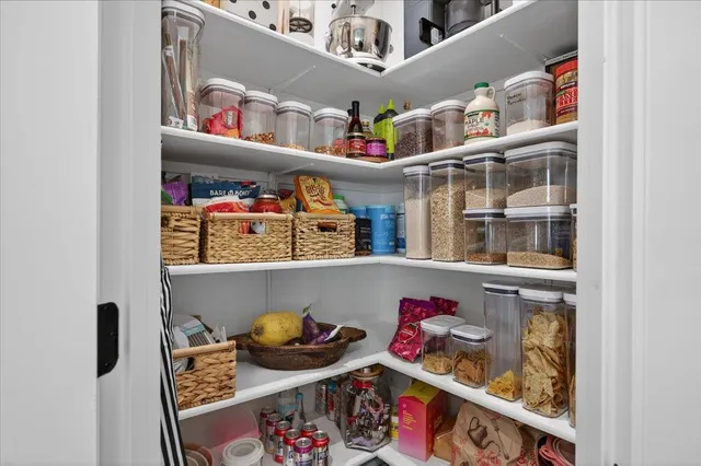 a view of a room with wooden floor and furniture