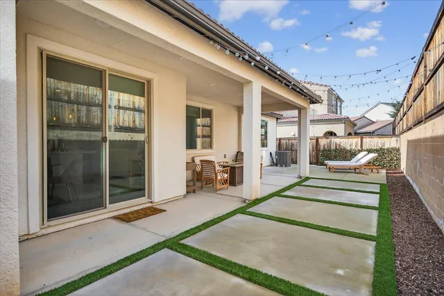 a view of a patio with table and chairs