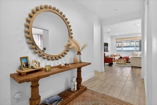 a view of a livingroom with furniture and a mirror
