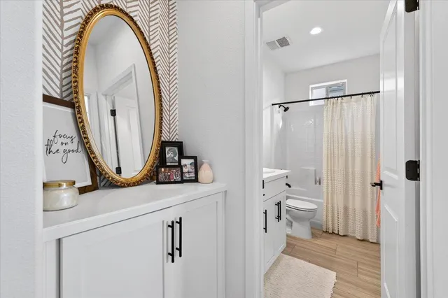 a bathroom with a toilet a sink and a mirror