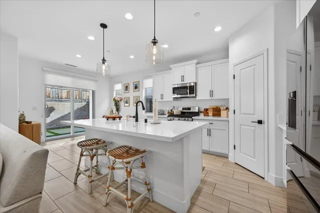 a large white kitchen with lots of counter space and appliances