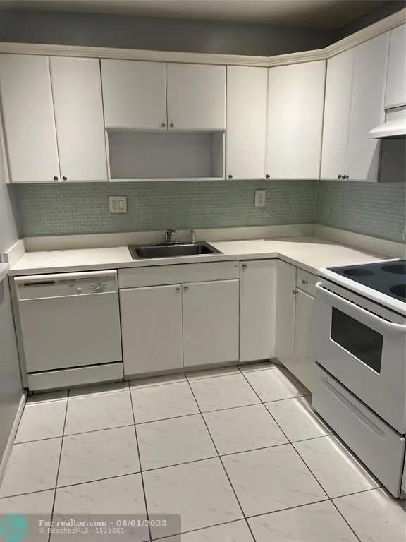 4131 Northwest 88th Avenue, Unit 206 Coral Springs, FL 33065 - Photo 1 of 41 a kitchen with cabinets and appliances